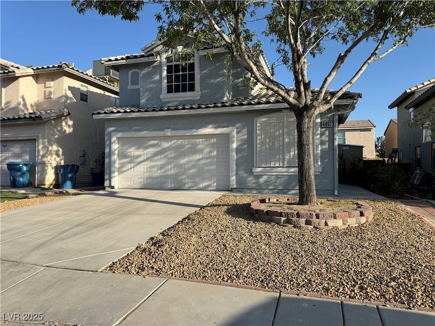 View of front of home featuring a garage, driveway