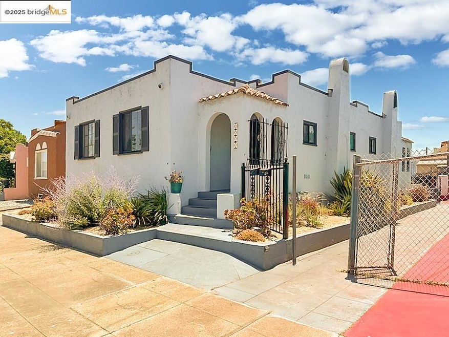Mediterranean / spanish home with a gate and stucco siding