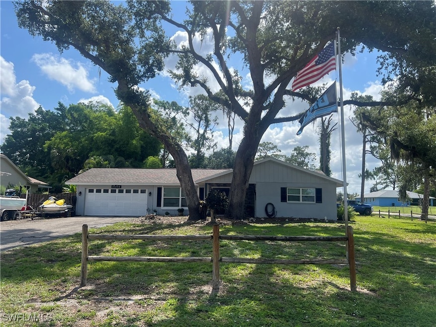Ranch-style house featuring driveway and a garage