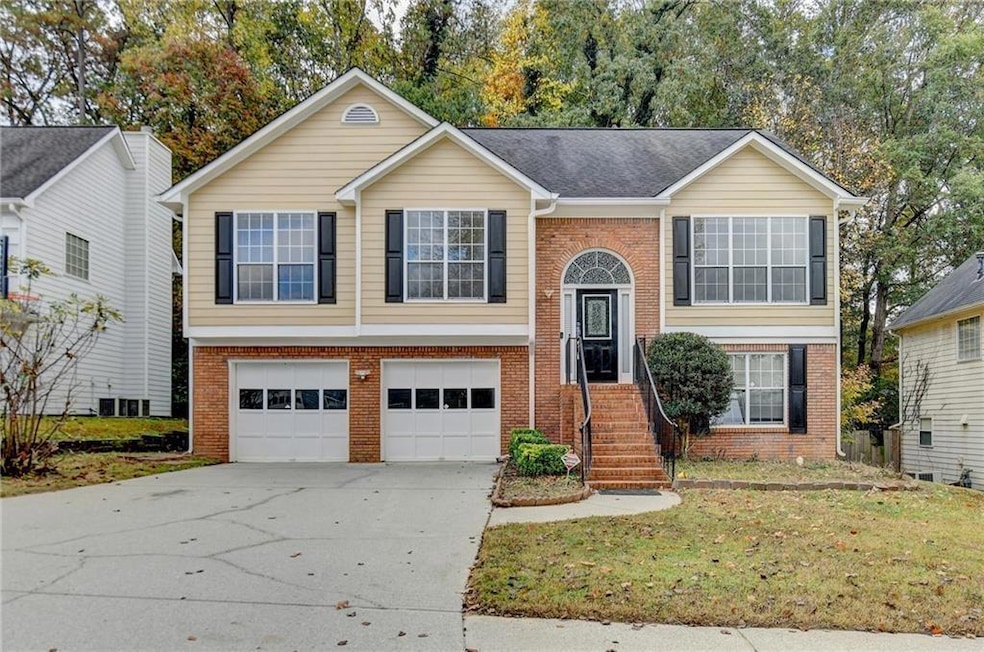 Raised ranch with driveway, an attached garage, a 