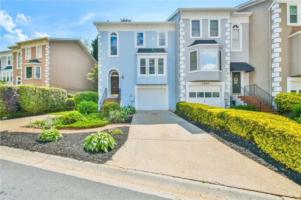 View of front facade featuring a garage, driveway,