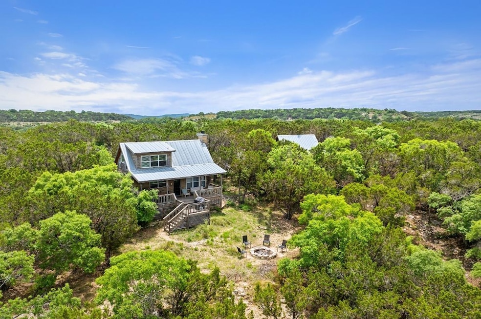 View from above of property with a heavily wooded