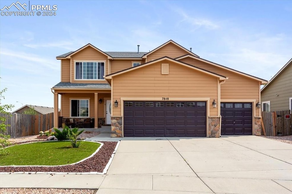 Craftsman inspired home featuring a garage and a f