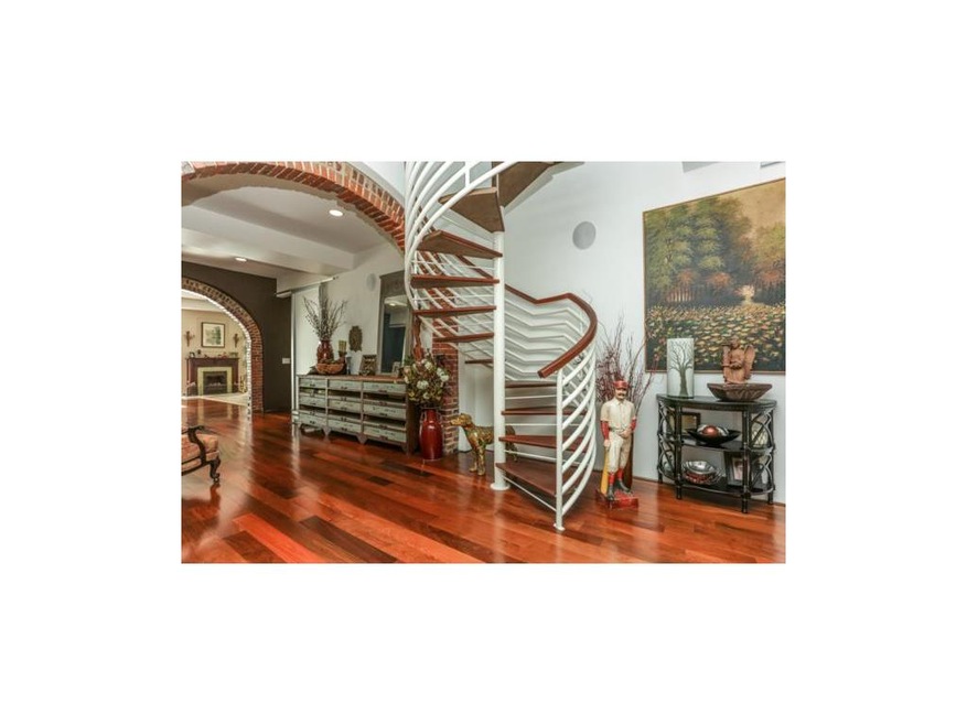 Extra wide hallway with beautiful brick arches.  C