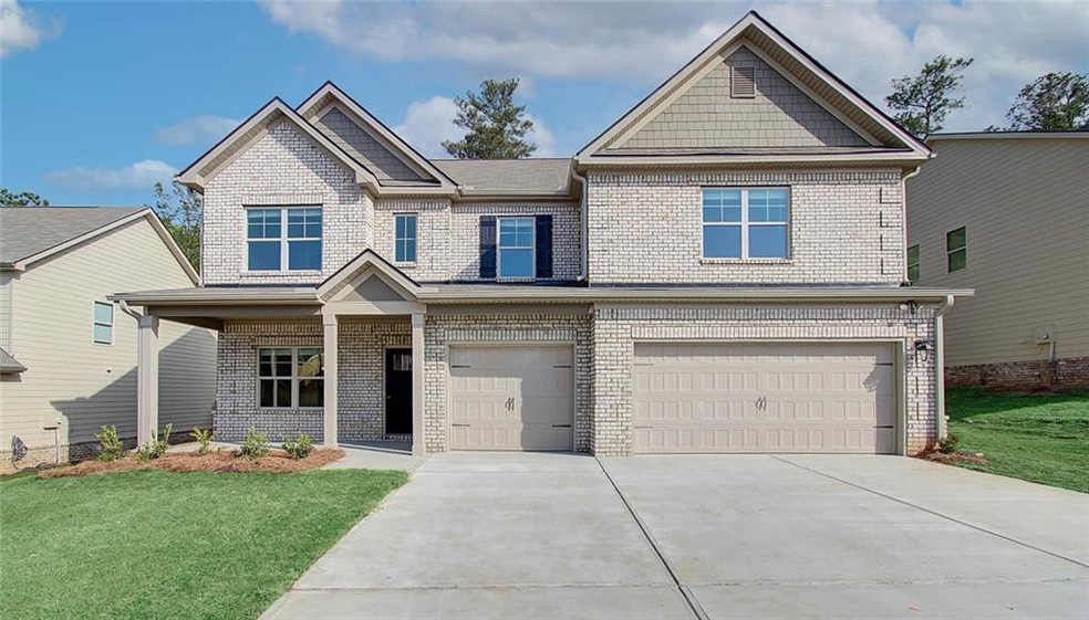Craftsman inspired home with a front lawn and a ga