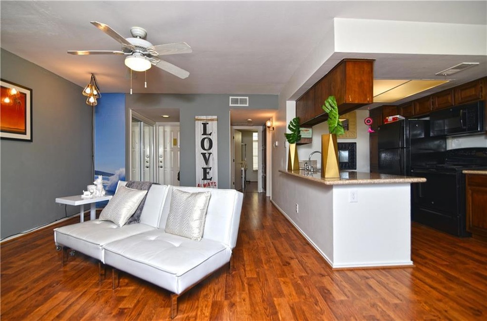 Living room and kitchen, with a bar for entertaini