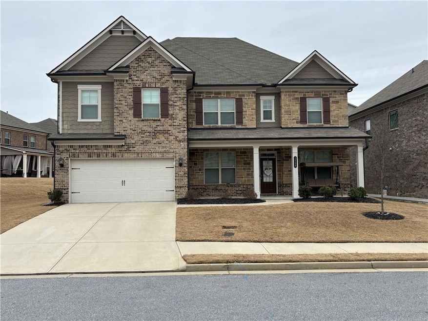 Craftsman inspired home with an attached garage, covered porch, brick siding, and concrete driveway