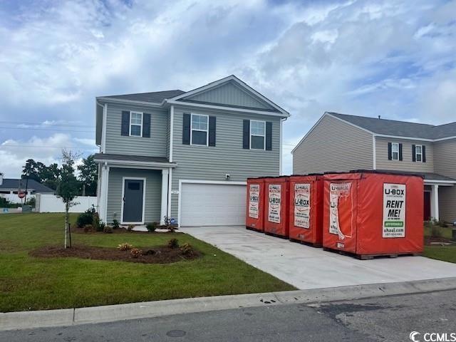 View of front of property featuring a garage and a