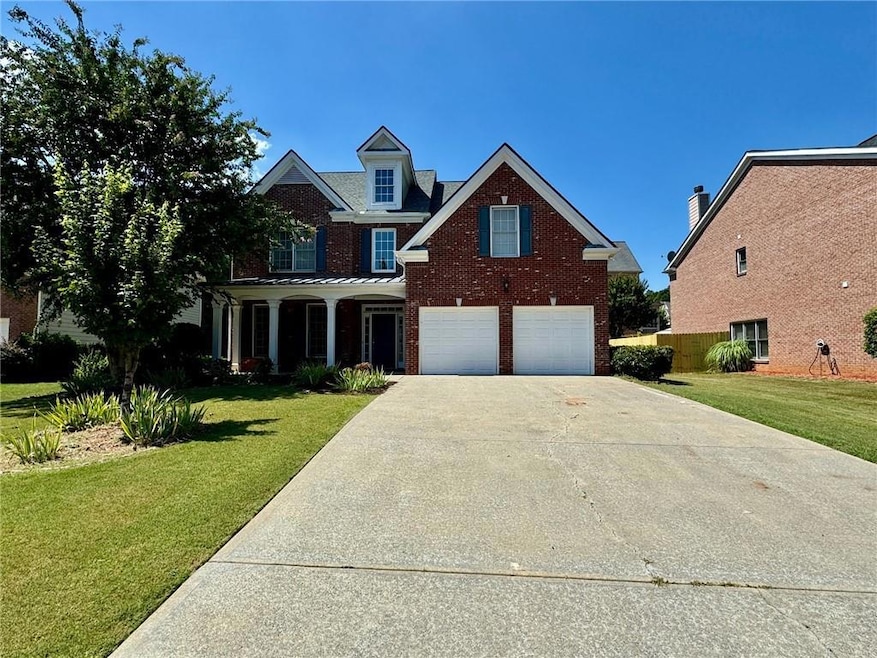 Front facade featuring a front lawn and a garage