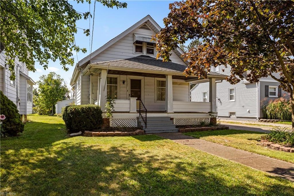 Bungalow featuring a porch and a front lawn
