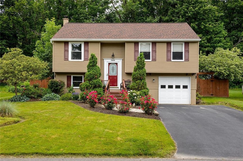 Front of home with added front deck, new windows and front door w/ storm dr, pavestone sidewalk, double wide driveway.