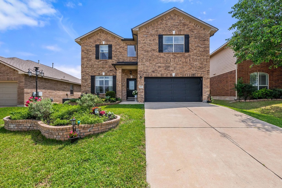 Traditional-style house with concrete driveway, b