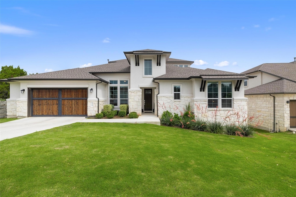 Prairie-style home with an attached garage, a fro