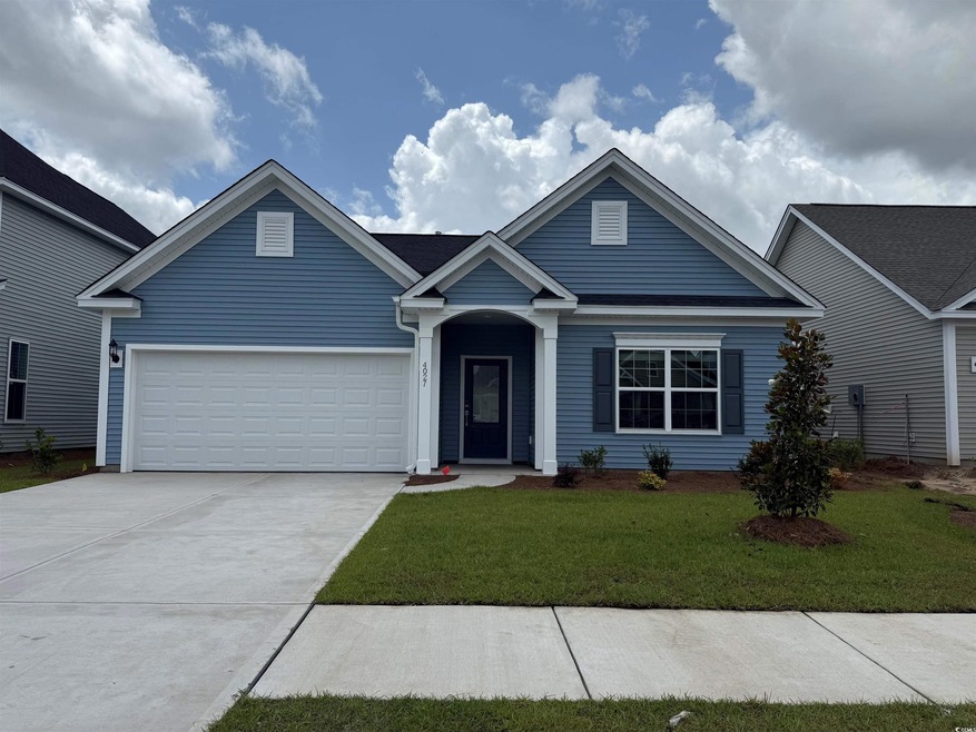 View of front of house with an attached garage, driveway, and a front yard