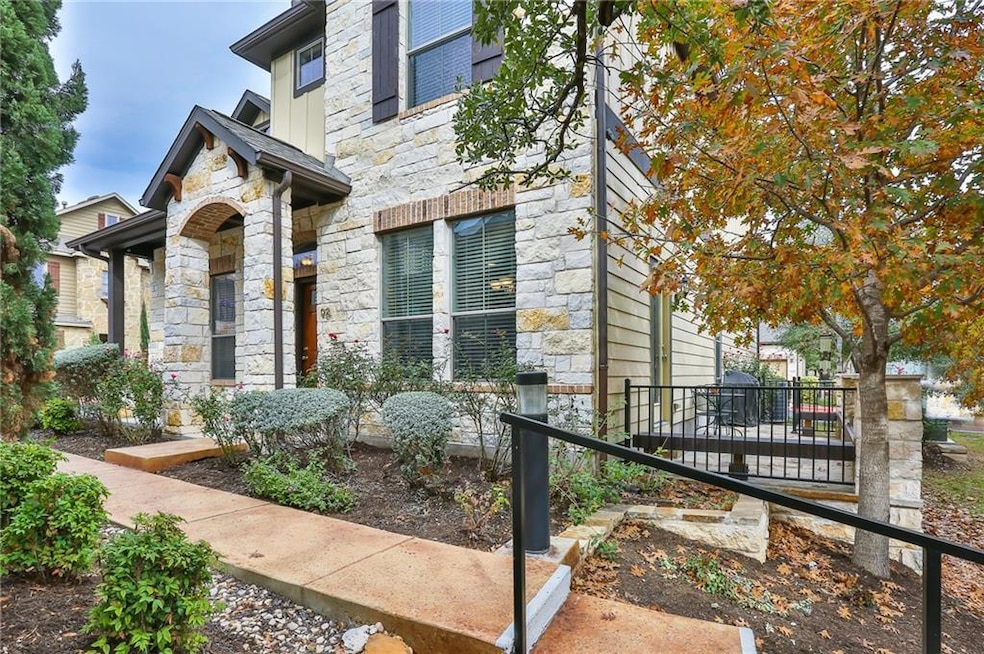 View of front of home with stone siding and fence