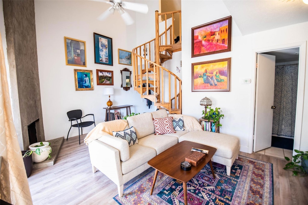 Living area featuring stairs, a ceiling fan, a la