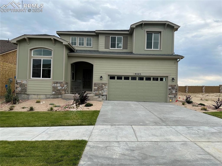 View of front of home with a garage and a front la