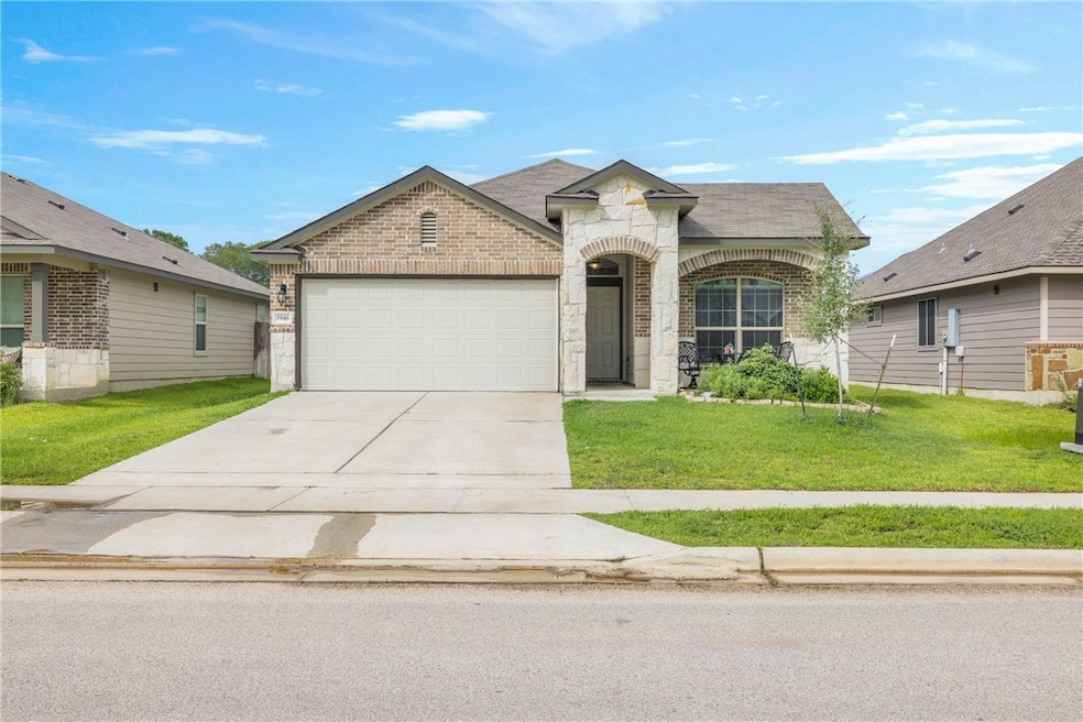 French provincial home with brick siding, driveway
