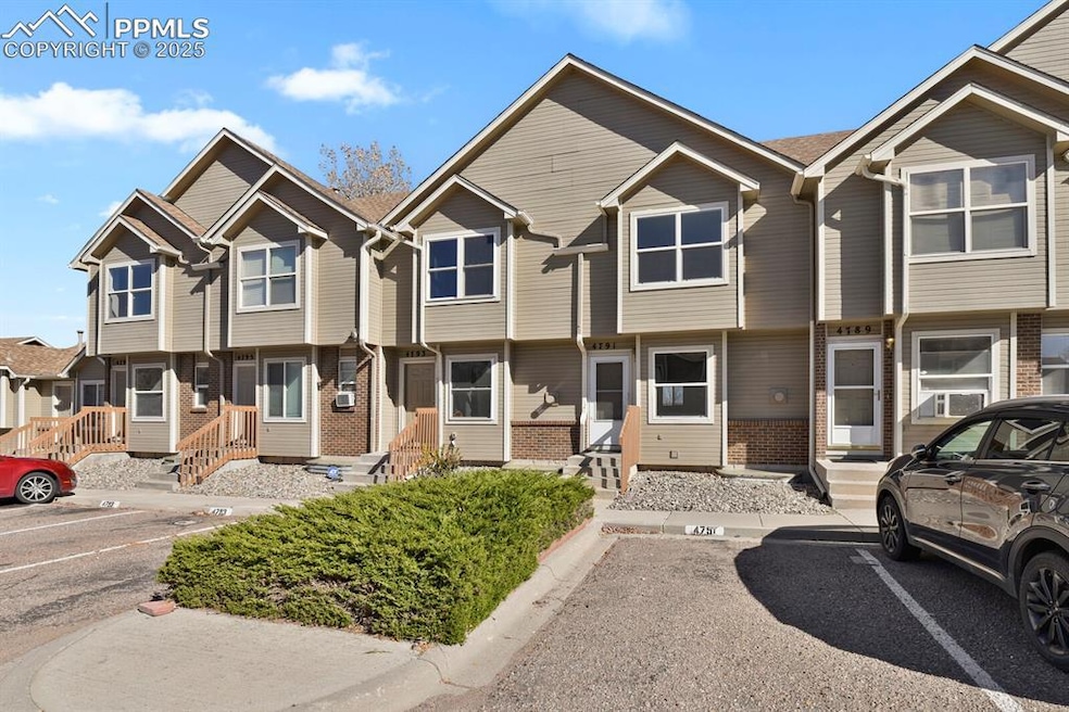 View of front of home featuring a residential view, uncovered parking, and brick siding