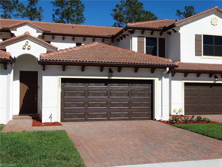 Mediterranean / spanish home featuring decorative driveway and stucco siding