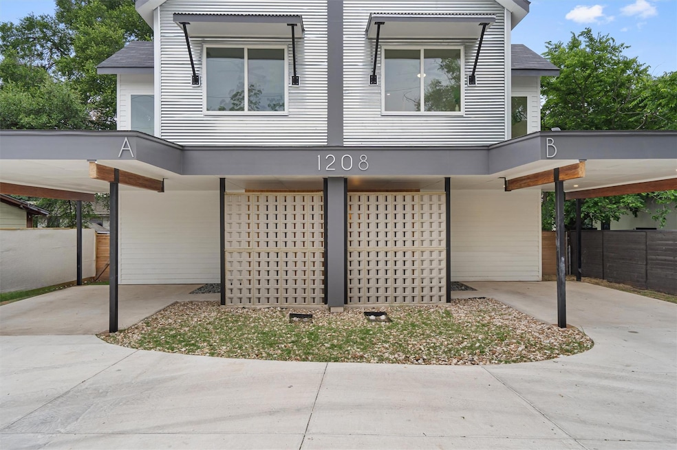 View of front of house with fence and a carport