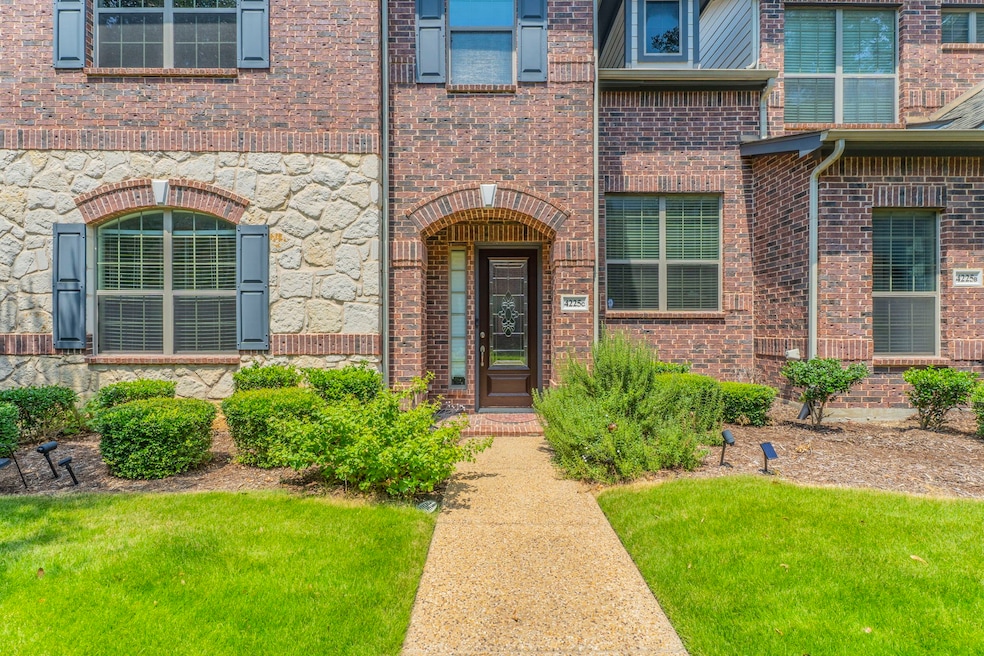Entrance to property featuring a lawn and brick siding