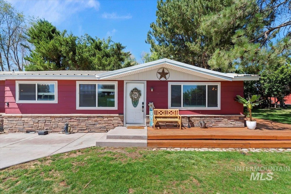 Ranch-style house with stone siding, a front lawn, and a deck
