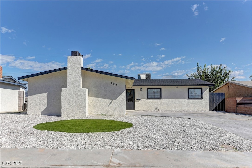 View of front of home featuring stucco siding and a chimney
