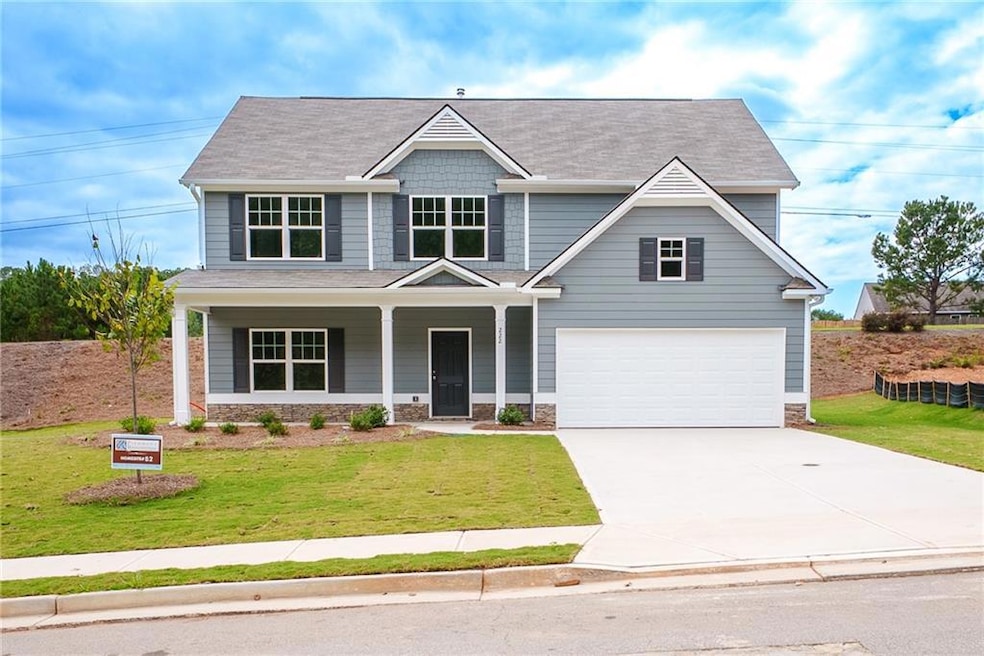 Craftsman-style house with a porch, stone siding, concrete driveway, roof with shingles, and a garage