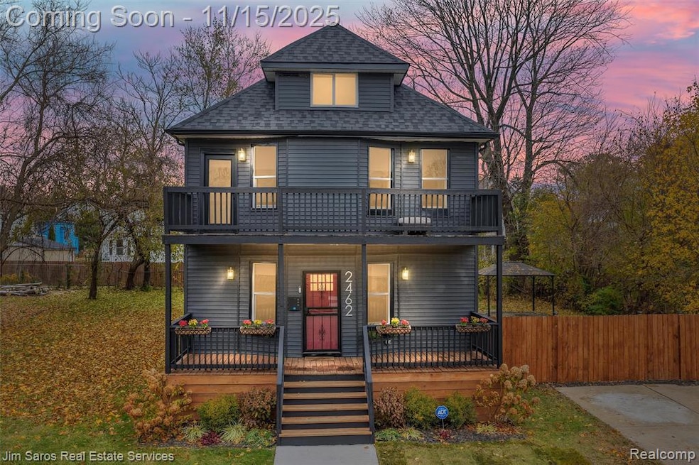 View of front of property featuring a shingled roof and covered porch