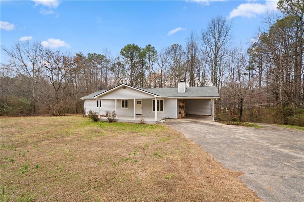 Single story home featuring a front lawn and a por