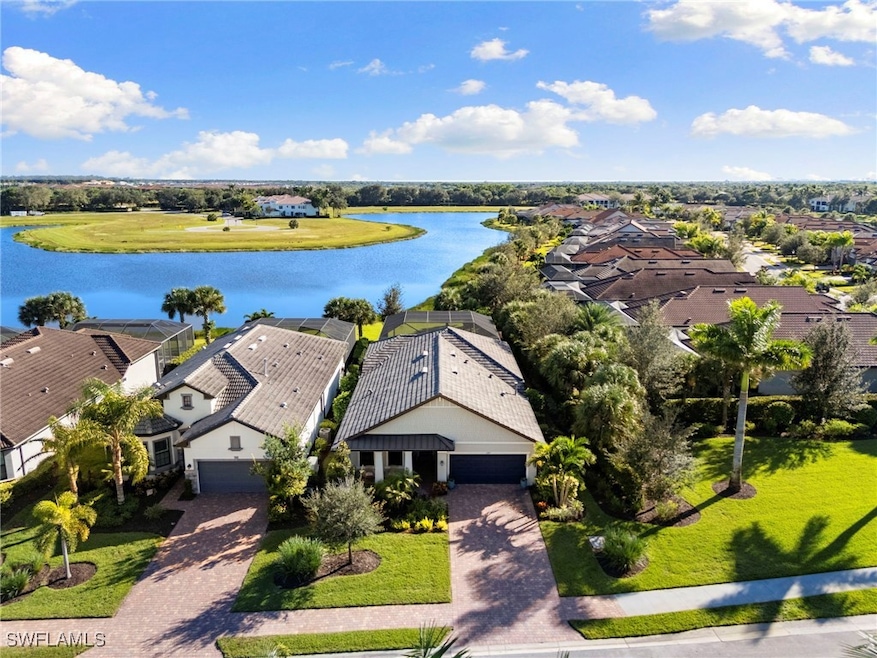 Aerial view of residential area featuring a large body of water
