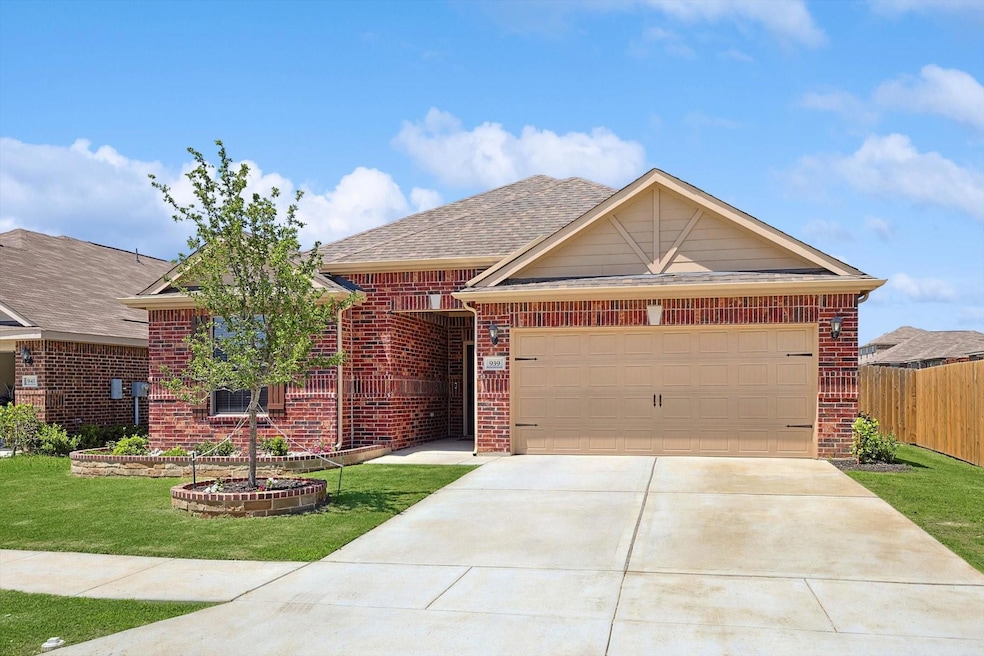View of front of home featuring a front yard and a garage