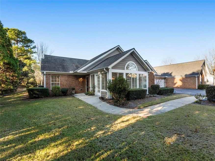 Single story home with a front lawn