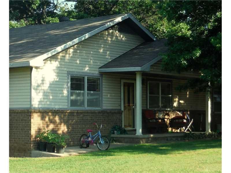 Exterior Front. Shaded front porch and door.