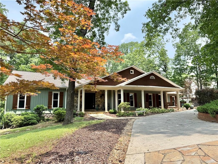 View of front of property with a porch and stone siding