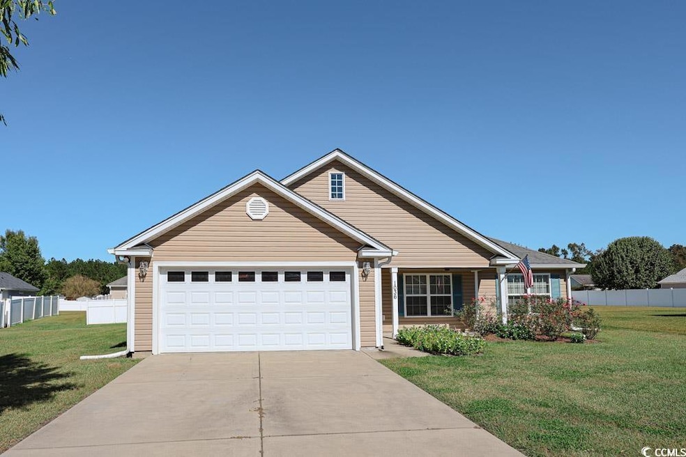 View of front facade featuring driveway, a garage, and a porch