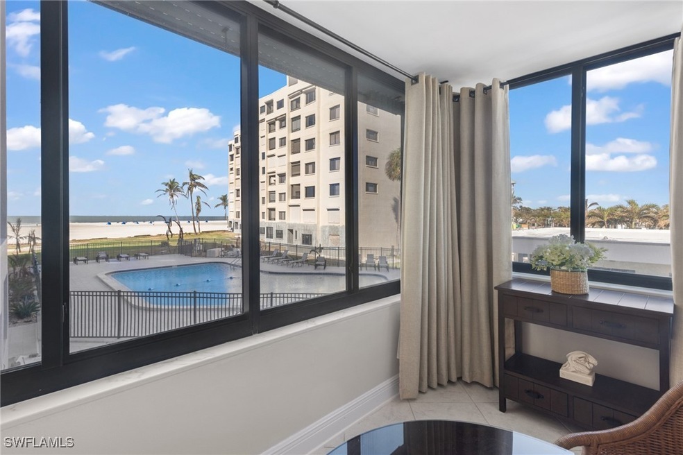 Sitting room featuring a water view and light tile