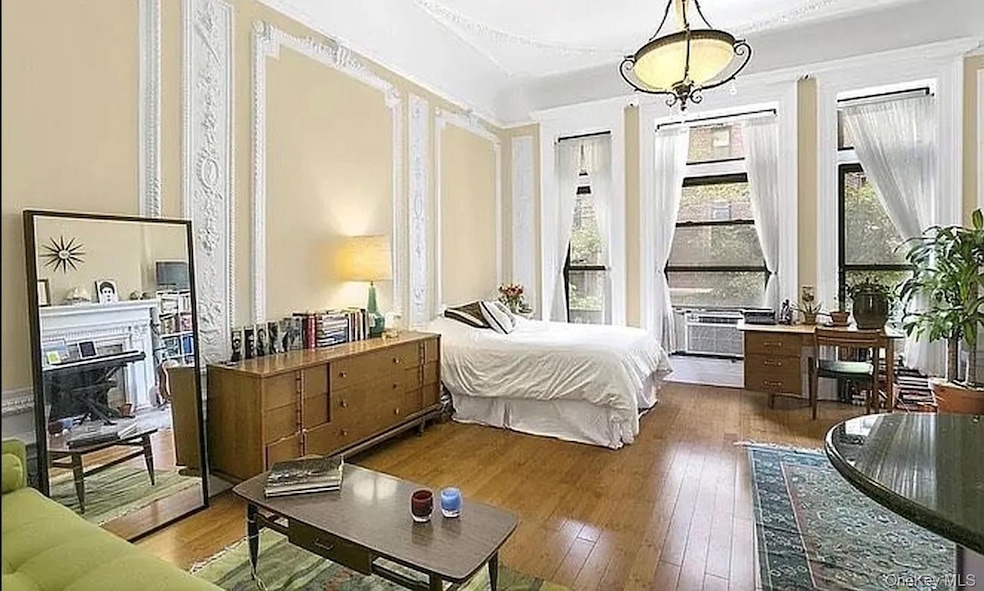 Bedroom featuring hardwood / wood-style floors and a fireplace