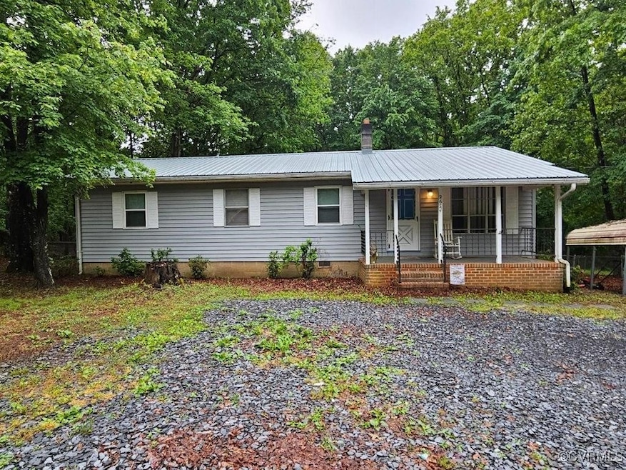 Ranch-style home featuring covered porch, metal ro