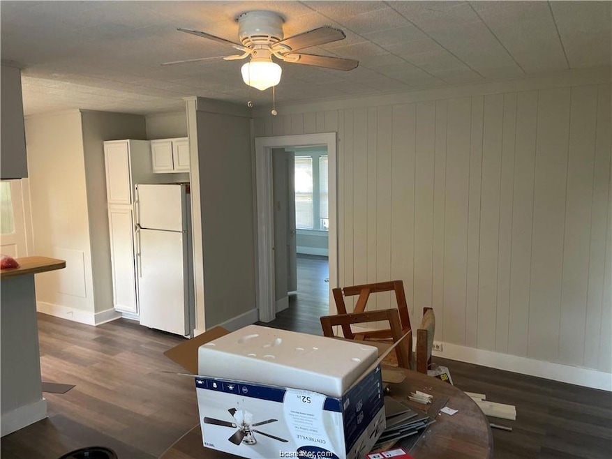 Dining room featuring baseboards, dark wood-type f
