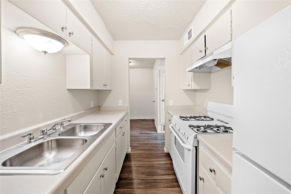 Kitchen with white appliances, under cabinet rang