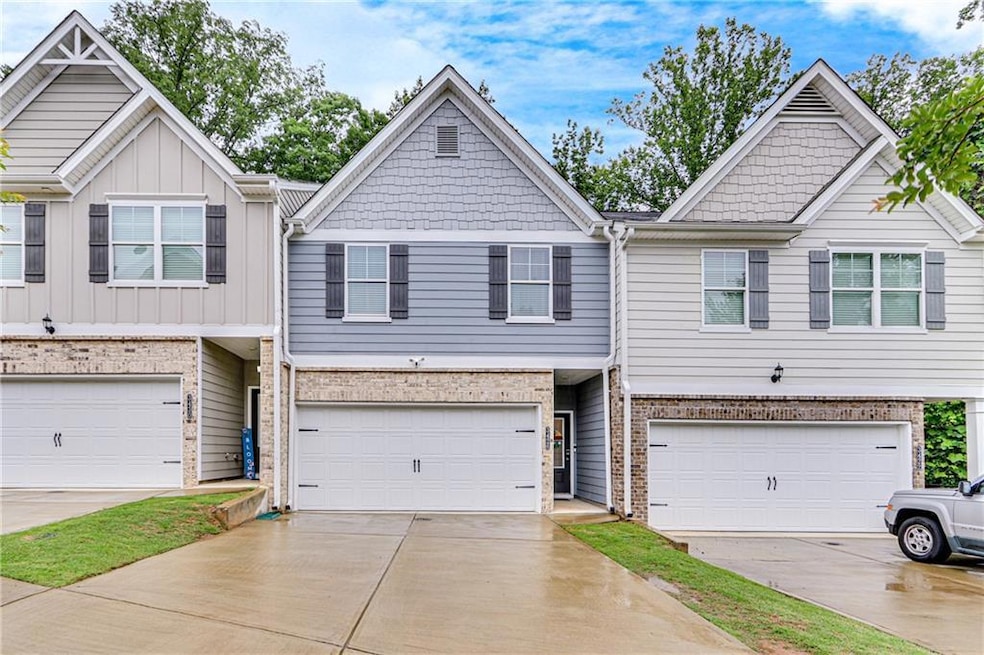 View of property featuring an attached garage, con