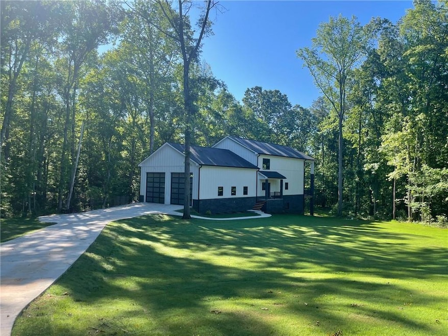 View of property exterior featuring a lawn, concre