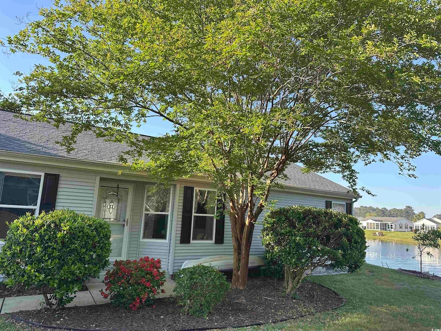 View of property exterior with a yard, roof with s