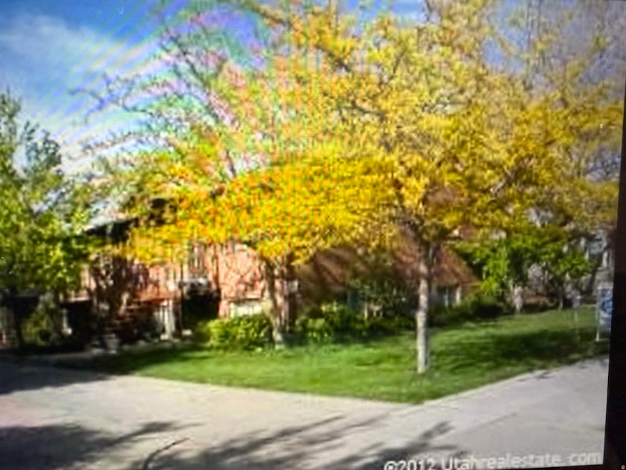 View of home's community with a lawn