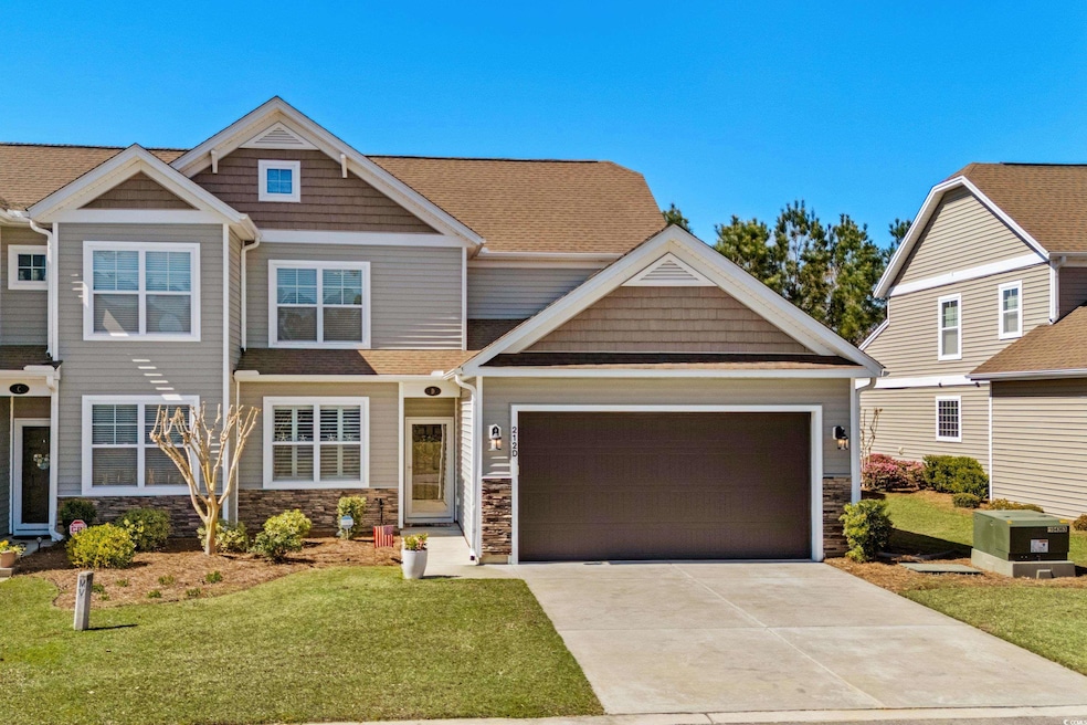 Craftsman house featuring driveway, a front yard, 