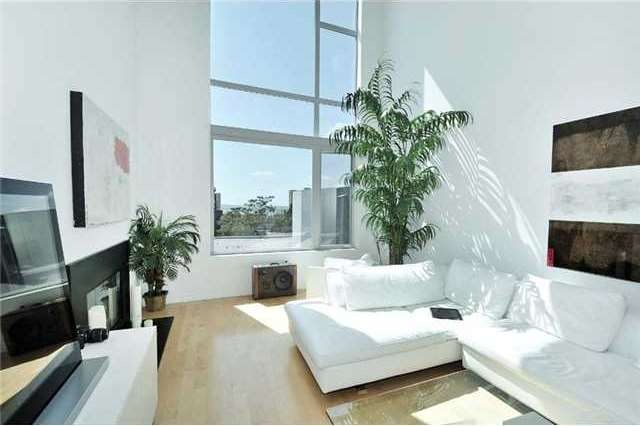 You will be blown away by this unique 2-story loft at the Mills! It enjoys soaring ceilings, gleaming hardwood floors and massive view windows in the living room!
