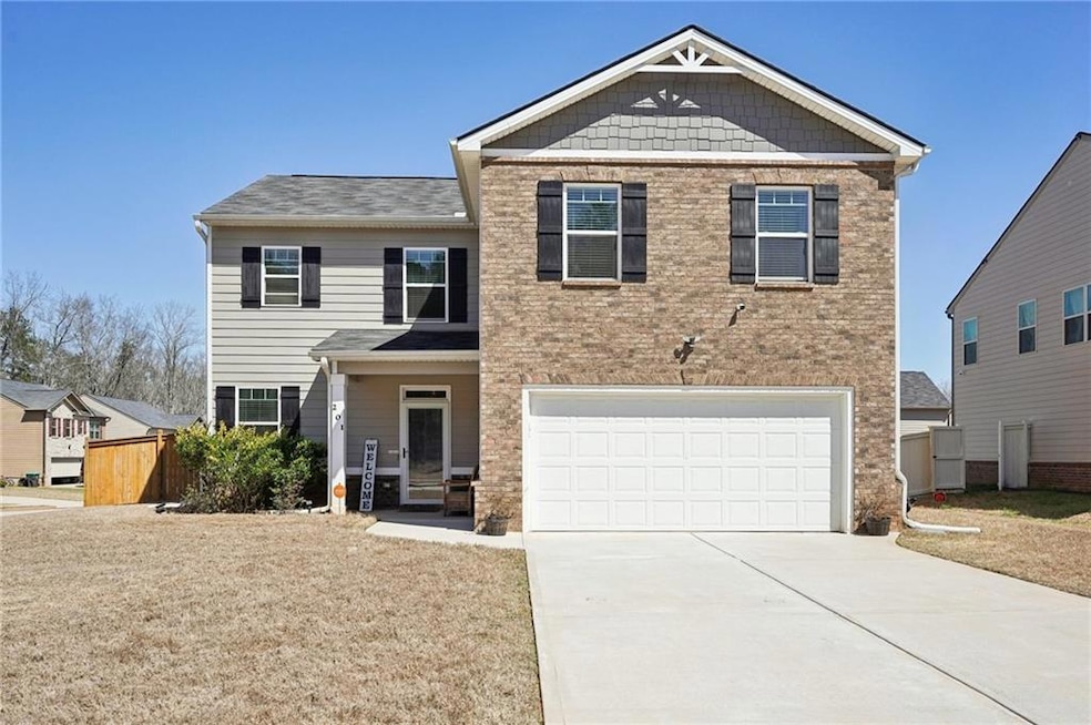 View of front of home featuring a garage and drive