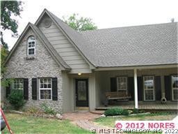 FRONT ELEVATION WITH STONE AND WRAP AROUND PORCH